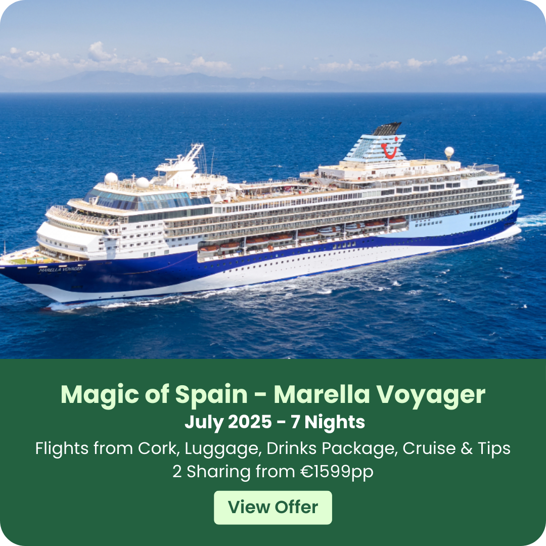 Cruise ship sailing on the ocean under a clear blue sky.