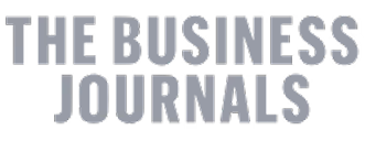 'The Business Journals logo in gray text on transparent background.'