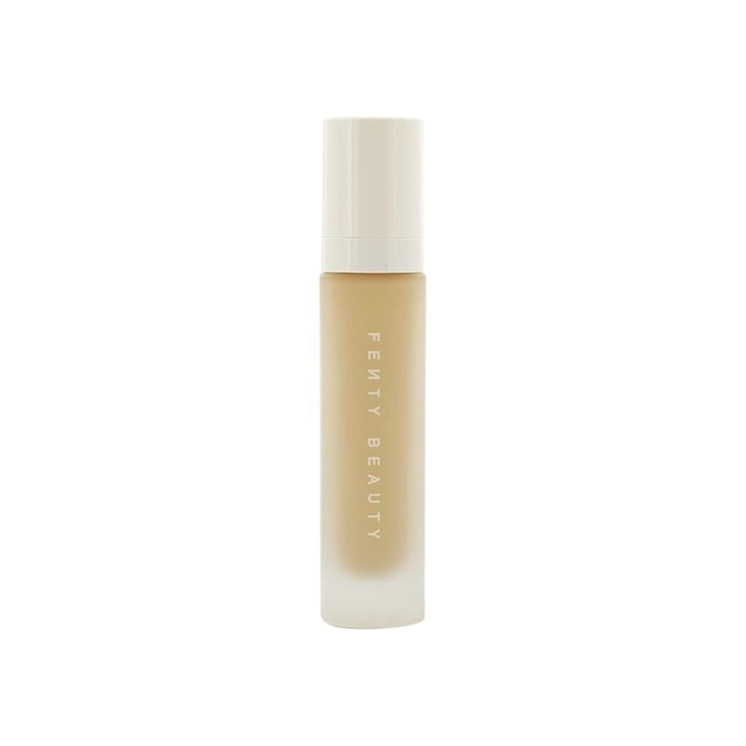 A bottle of Fenty Beauty foundation in a frosted glass bottle with a white cap on a white background.