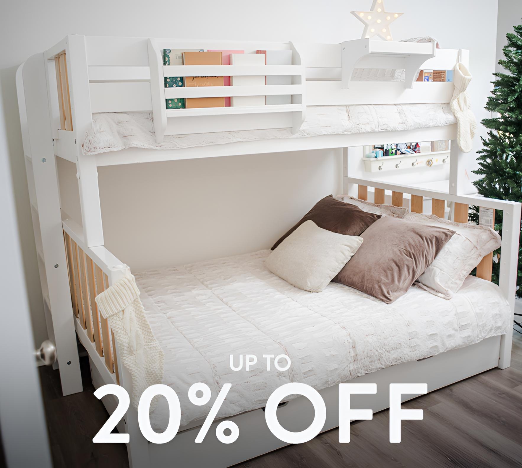 White wooden twin-over-full bunk bed in children's bedroom with neutral cozy bedding and pillows, modern kids' bunk bed — up to 20% off sale.
