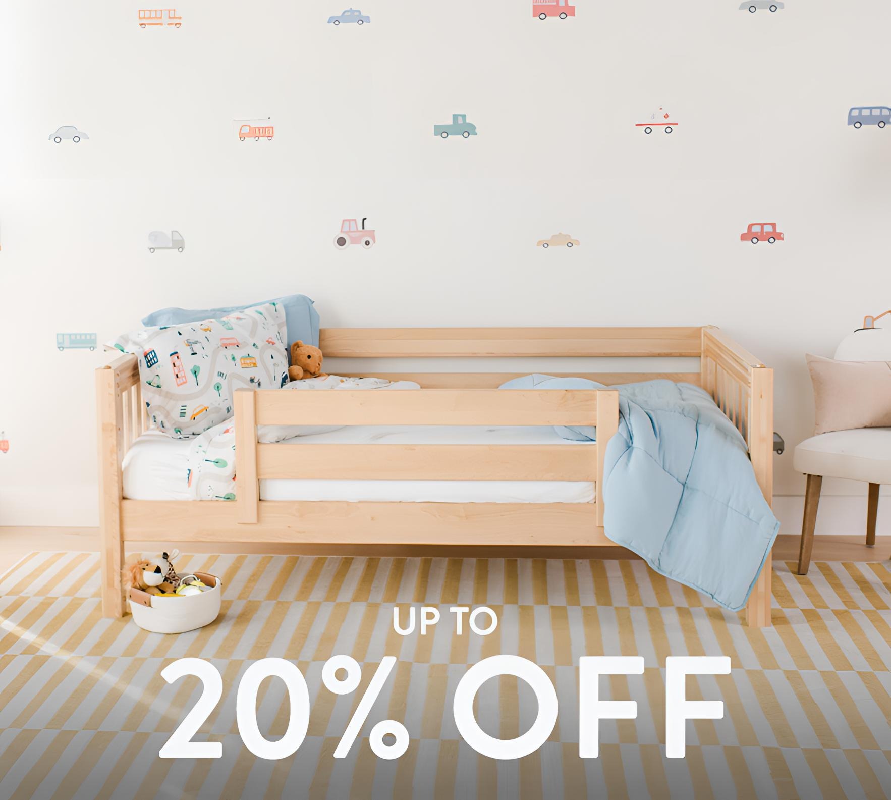 Natural wood toddler bed with light blue bedding and car wall decals in children's nursery, kids furniture sale up to 20% off.