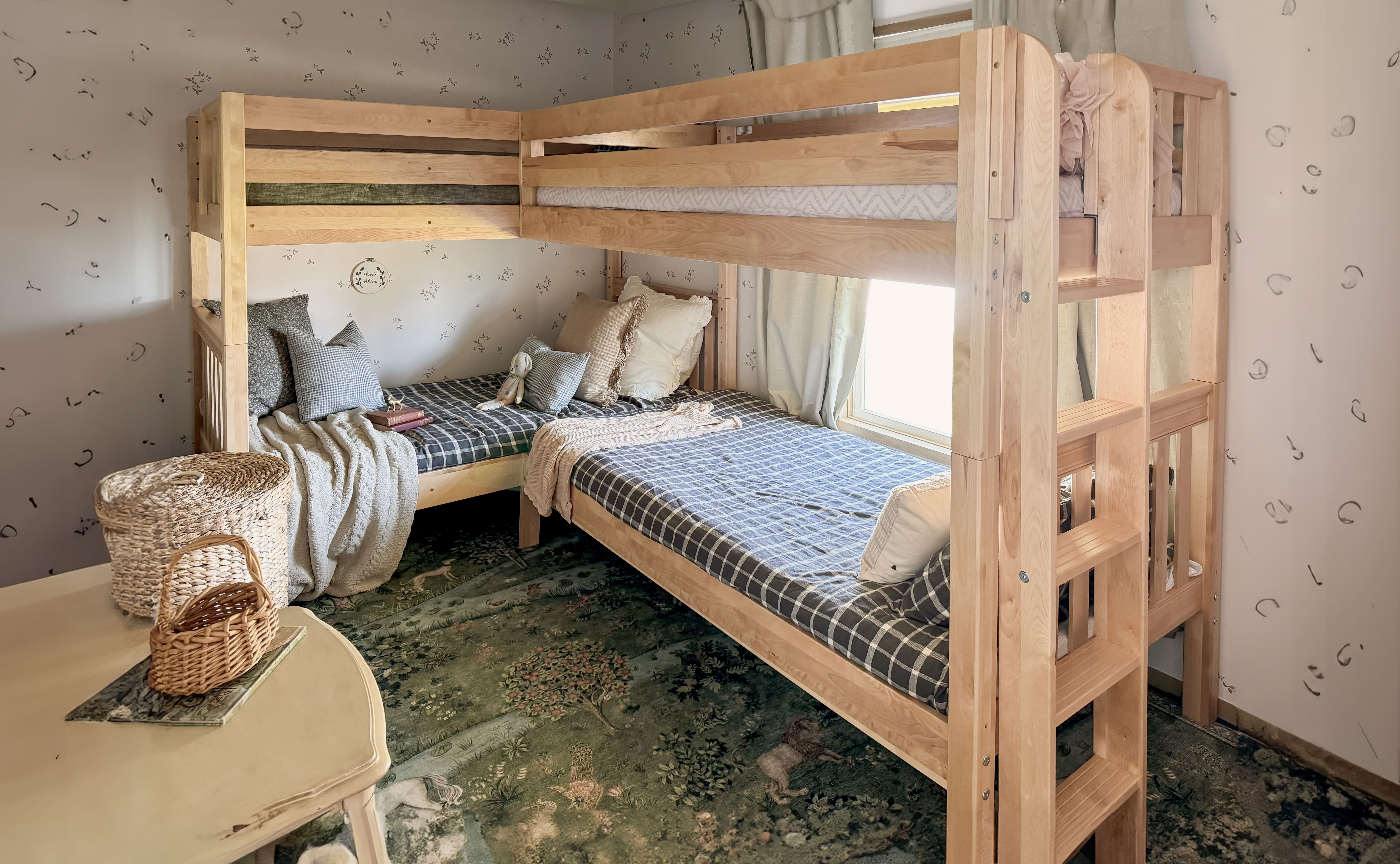 Rustic room with bunk beds, a wooden table, chairs, and decorative chandelier.
