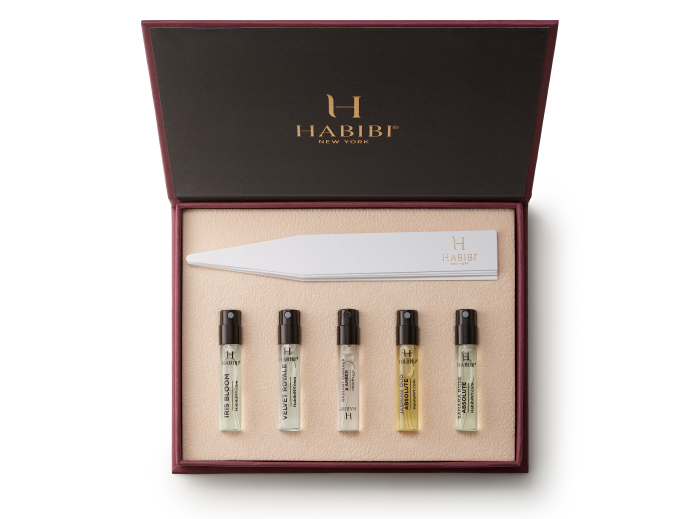 Open box with five perfume vials and paper strips inside.