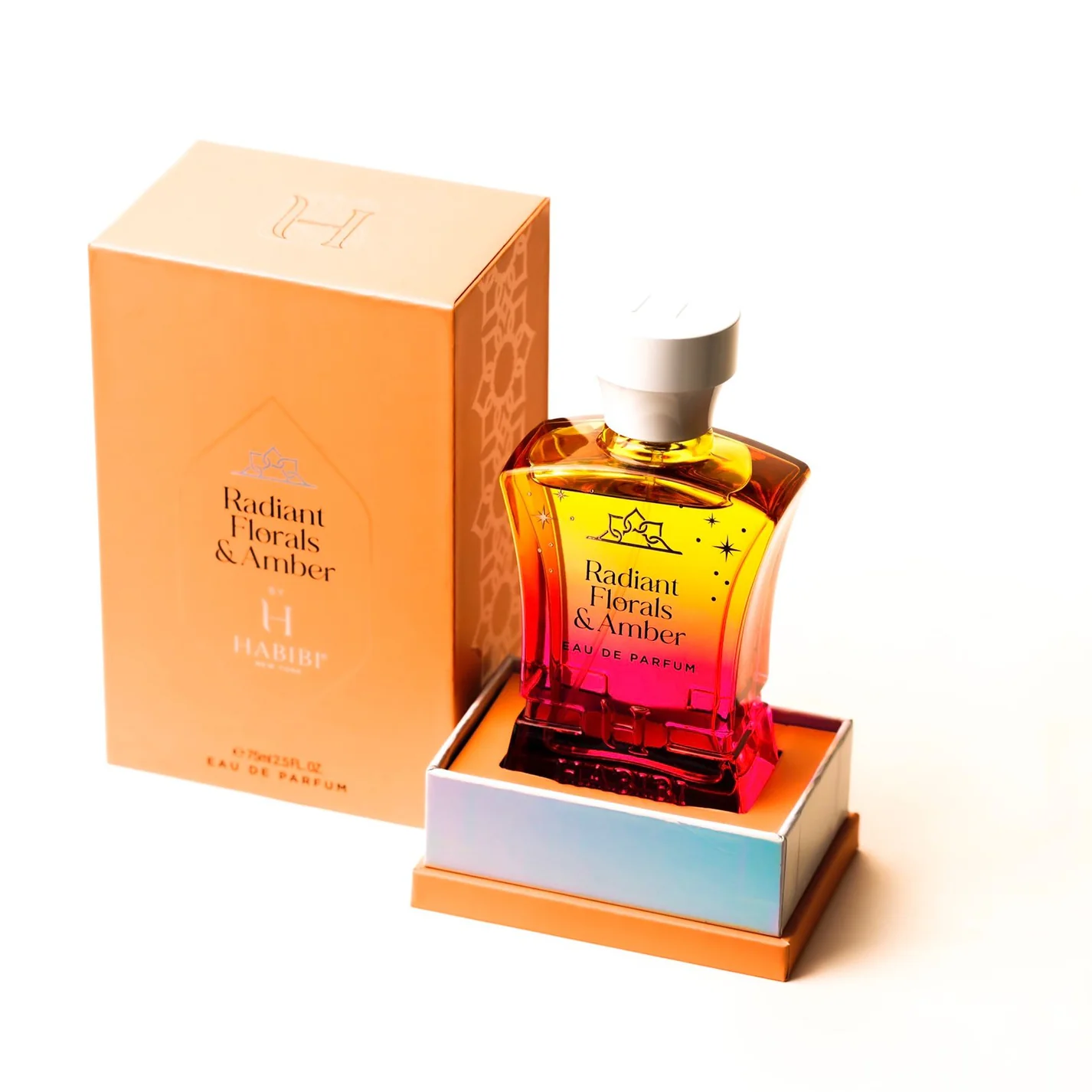 Perfume bottle labeled 'Radiant Florals & Amber' with matching orange box.