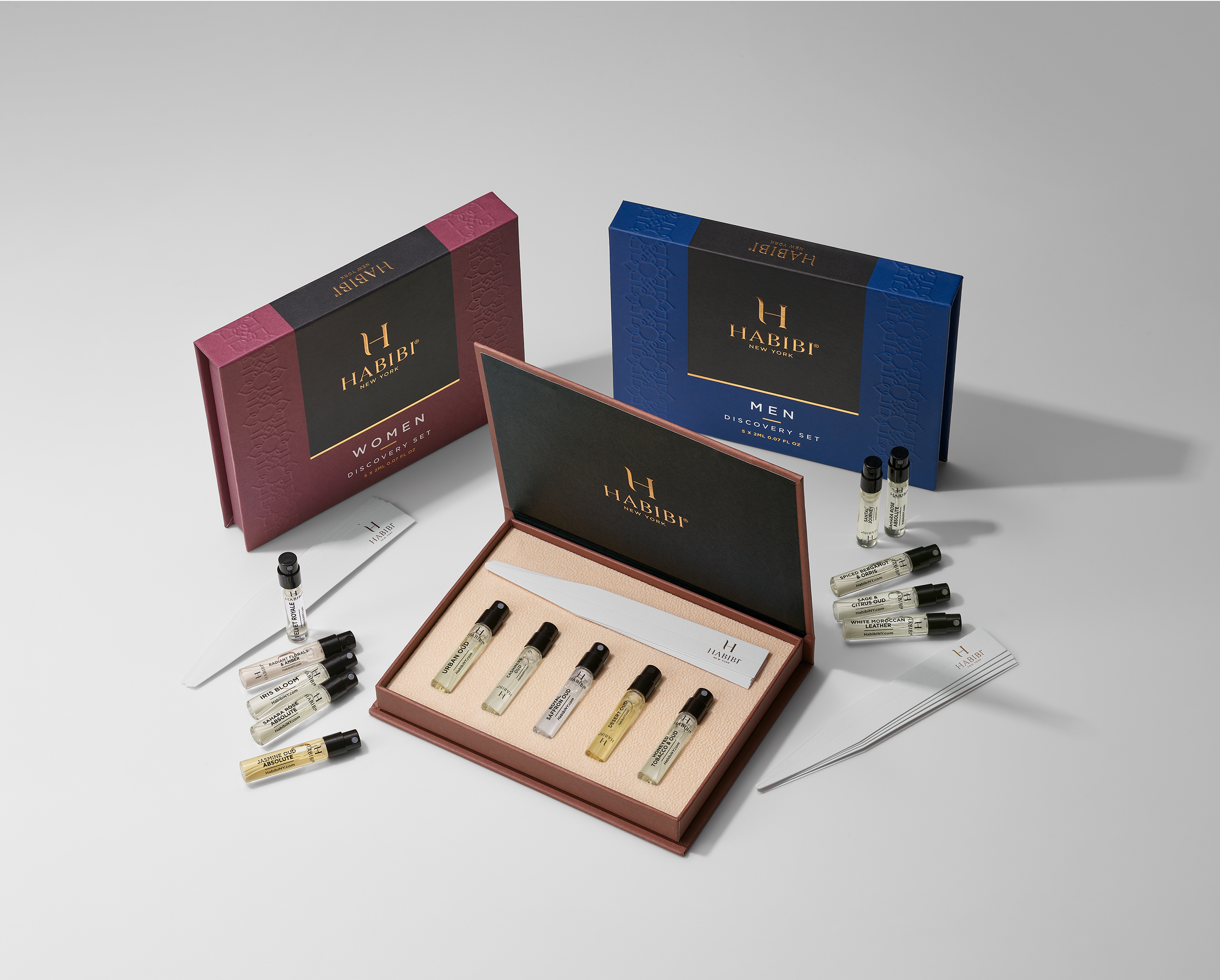 A display of men's and women's fragrance discovery sets with vials and tester strips.