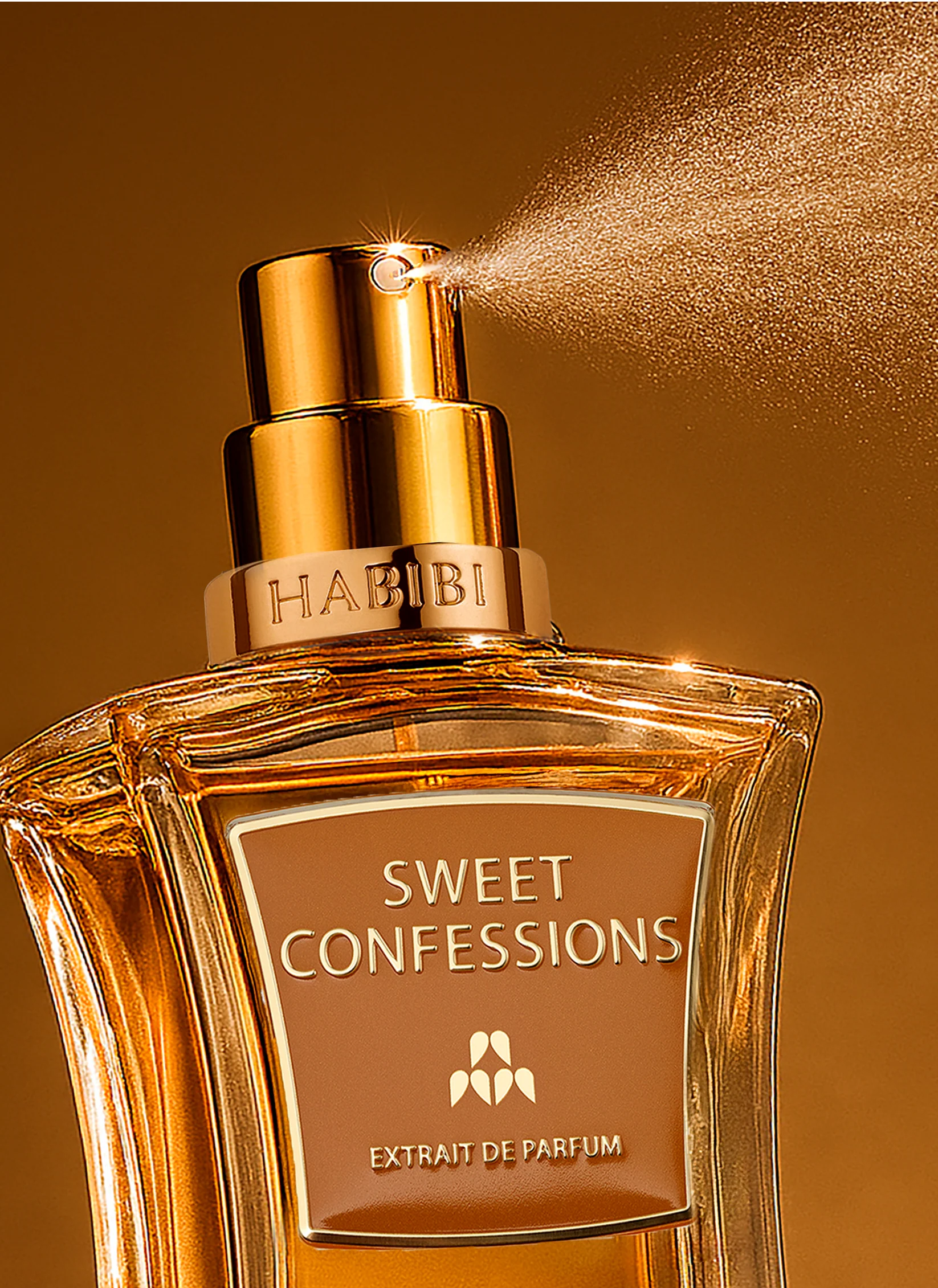 Perfume bottle spraying mist, labeled 'Sweet Confessions' by 'Habibi.'