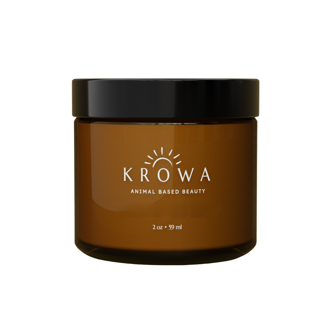 Amber jar with black lid, labeled 'KROWA Animal Based Beauty'.