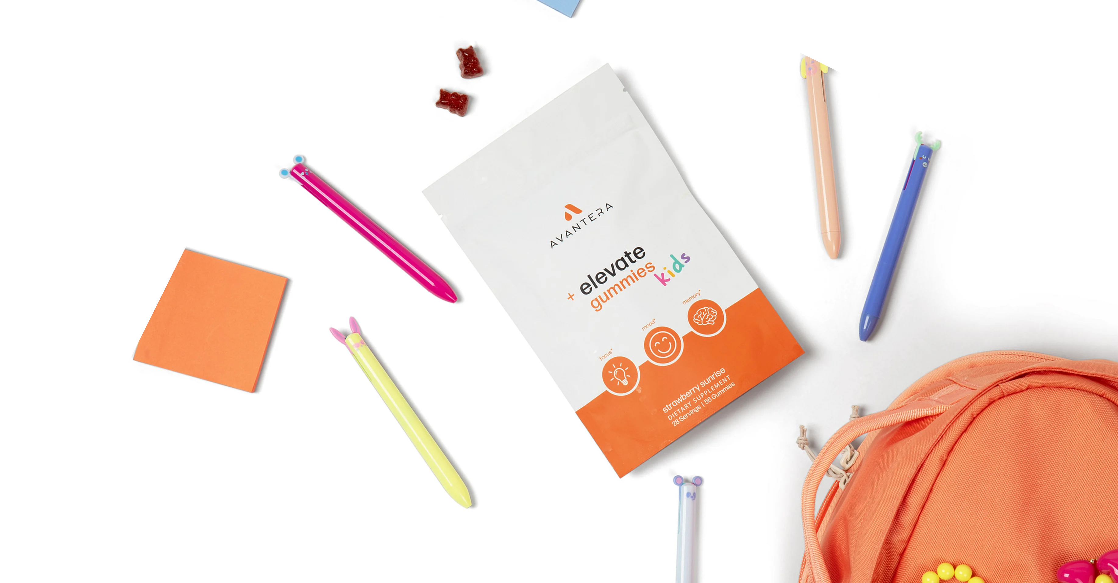 A pouch of Avantera Elevate Gummies for kids arranged with pens, gummies, and an orange backpack.