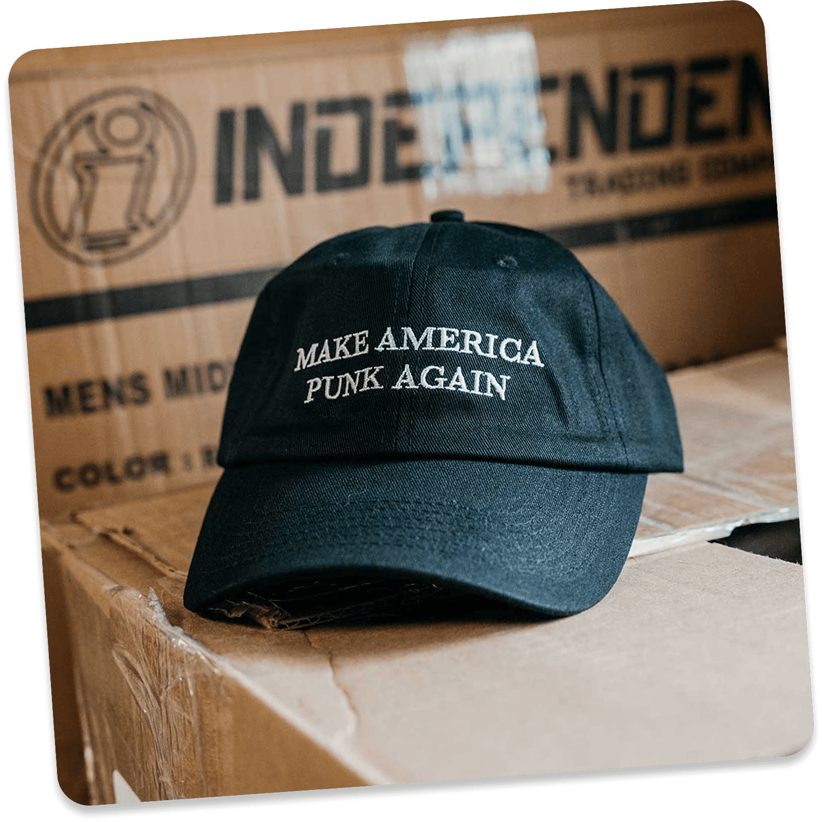 Black cap with 'Make America Punk Again' text on cardboard boxes.