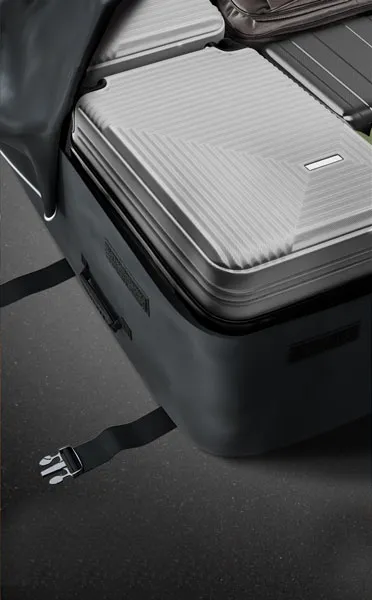 Open suitcase with neatly packed luggage inside.