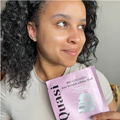 Person holding a pink Quasi collagen anti-wrinkle mask package.
