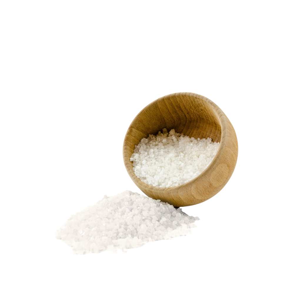 A wooden bowl of coarse sea salt, some spilled.