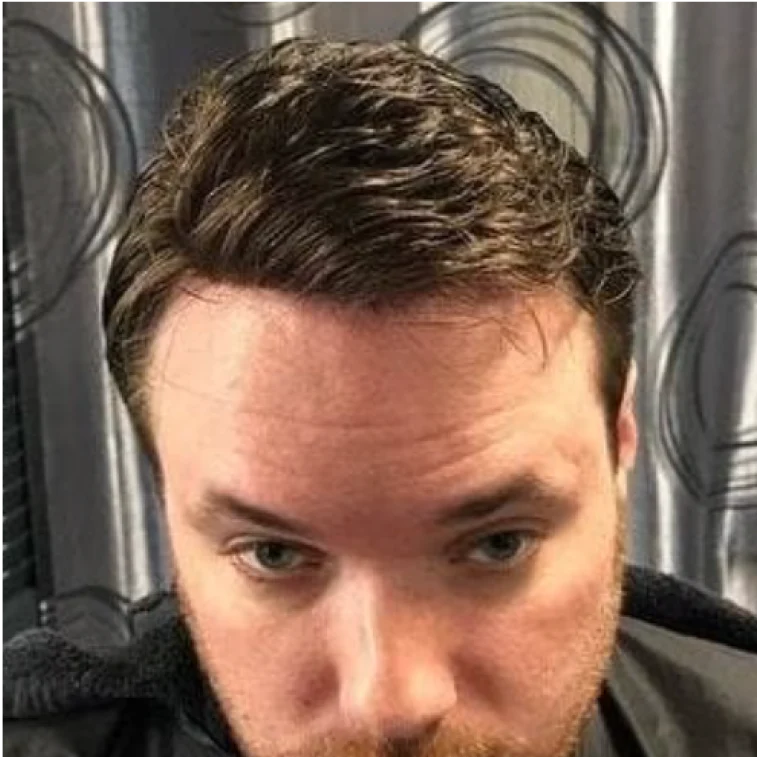 Close-up of a man's face with short brown hair.