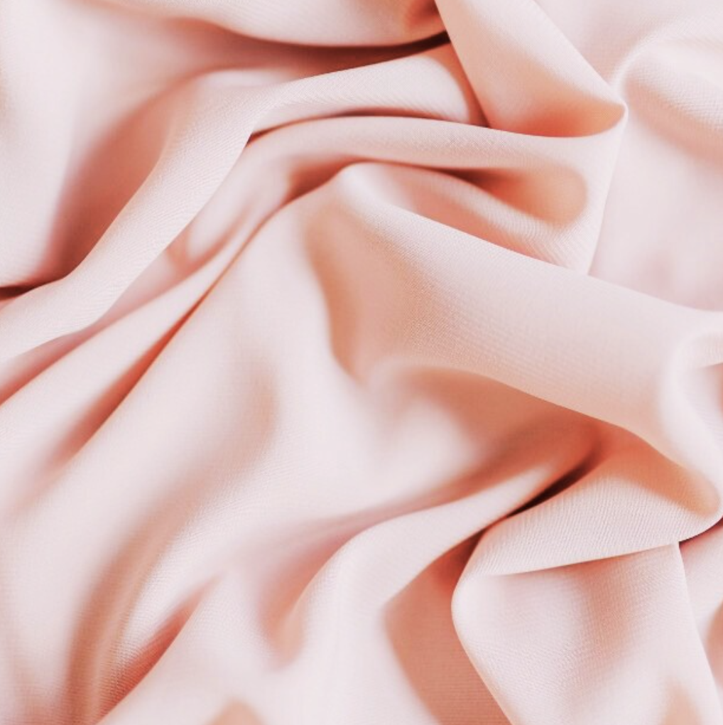 Close-up of soft, pink, crumpled fabric.