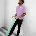 Ronald Acuña Jr. stretching with a mint CastleFlexx strap