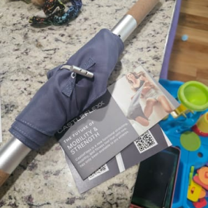 Customer photo of a gray CastleFlexx strap with metal bar and instruction card