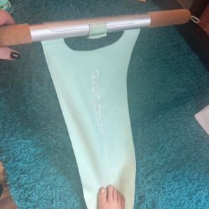 Customer photo of a mint CastleFlexx strap laid on a carpet