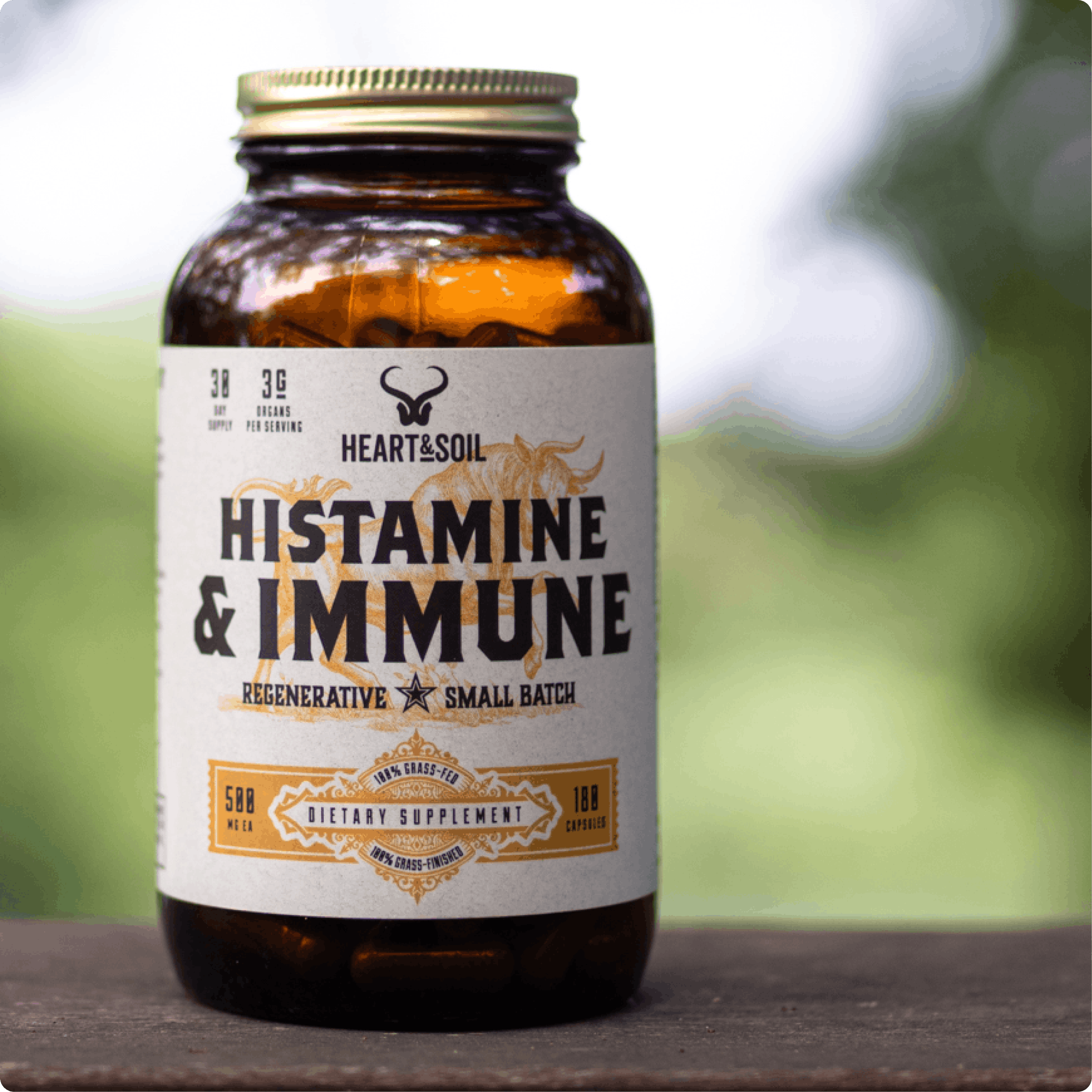 A bottle of Heart & Soil Histamine & Immune dietary supplement sitting on a wooden surface outdoors.