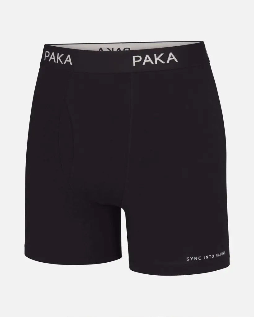 Black boxer briefs with 'PAKA' waistband and 'SYNC INTO NATURE' text.
