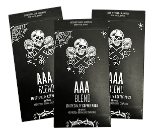 Three black coffee pod packages with skull and crossbones design.