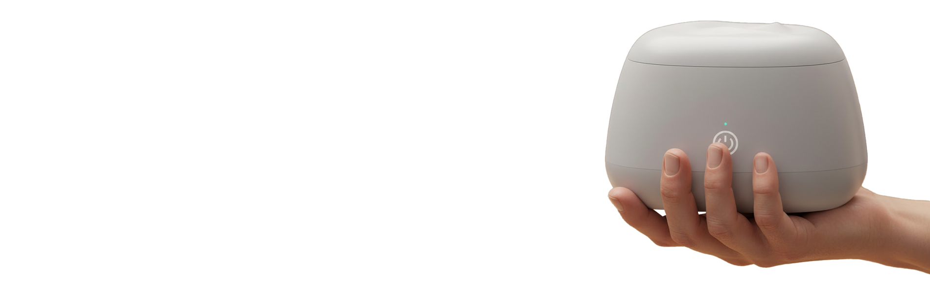 A hand holding a small, gray device with a power symbol on it.