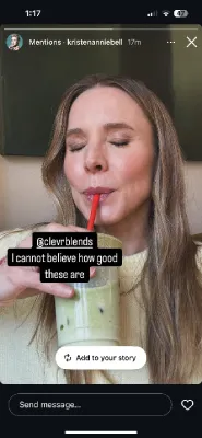 Instagram Story selfie of a smiling brunette woman sipping a green smoothie through a red straw, with captions praising how good it tastes.