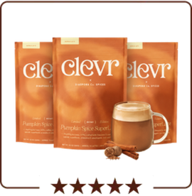 Three pouches of Clevr Pumpkin Spice SuperLatte mix with a prepared latte in a glass mug.