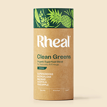 A cardboard tube of Rheal Clean Greens organic superfood blend, with a green and illustrated lid.