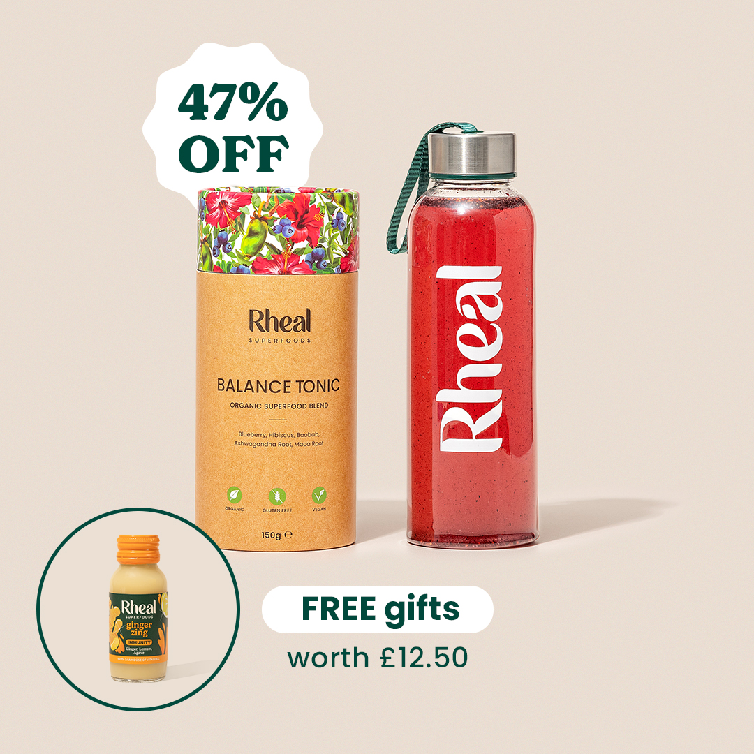 A promotional image for Rheal superfood products including Balance Tonic, a drink bottle, and a ginger shot.