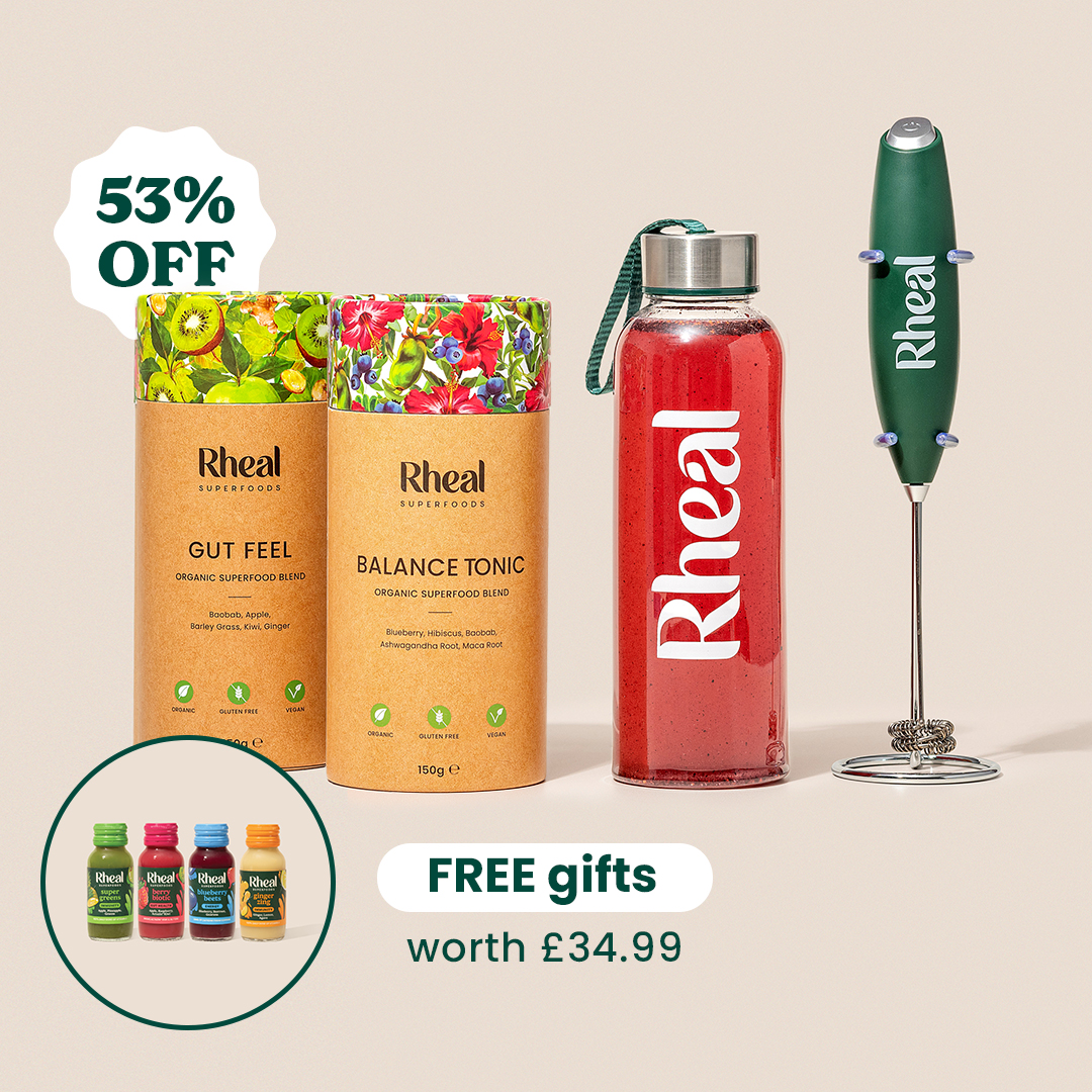 Rheal Superfoods products including powders, a drink bottle, a frother, and small shots with promotional text.