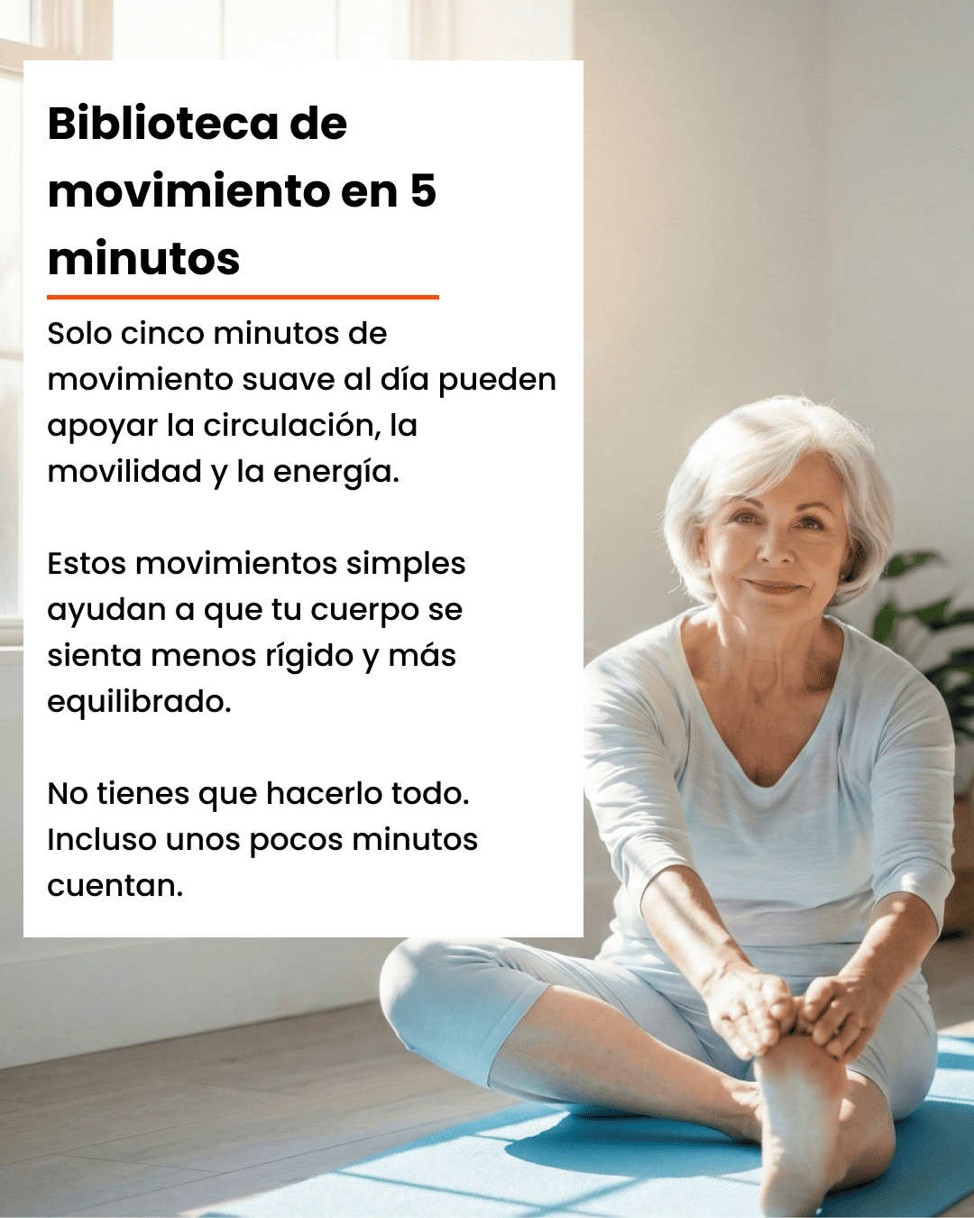 An older woman with white hair sits on a blue yoga mat in a sunlit room, stretching.