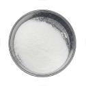 A top-down view of a small metal bowl filled with a fine white powder against a white background.