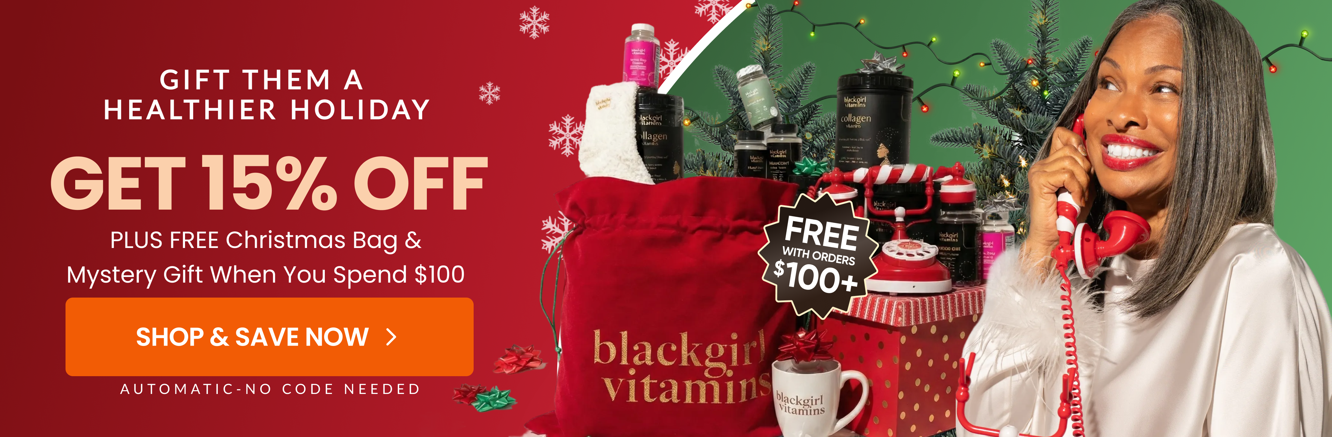 Smiling woman holding red phone with holiday gifts and decorations.