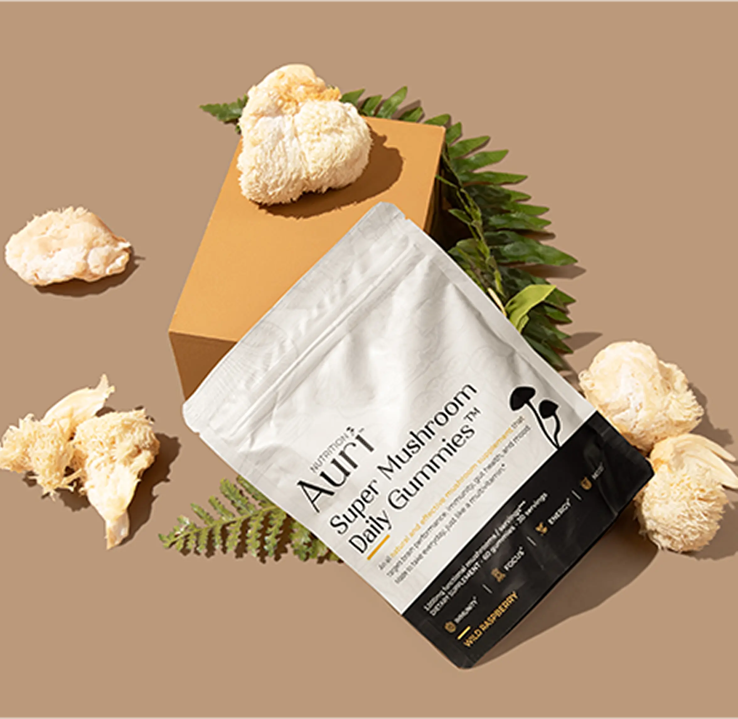 Package of mushroom gummies with mushrooms and leaves on a brown background.
