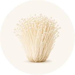 A circular image showing a cluster of enoki mushrooms against a light background.