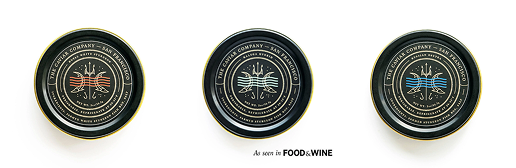 Three tins of The Caviar Company caviar with different colored labels against a white background.