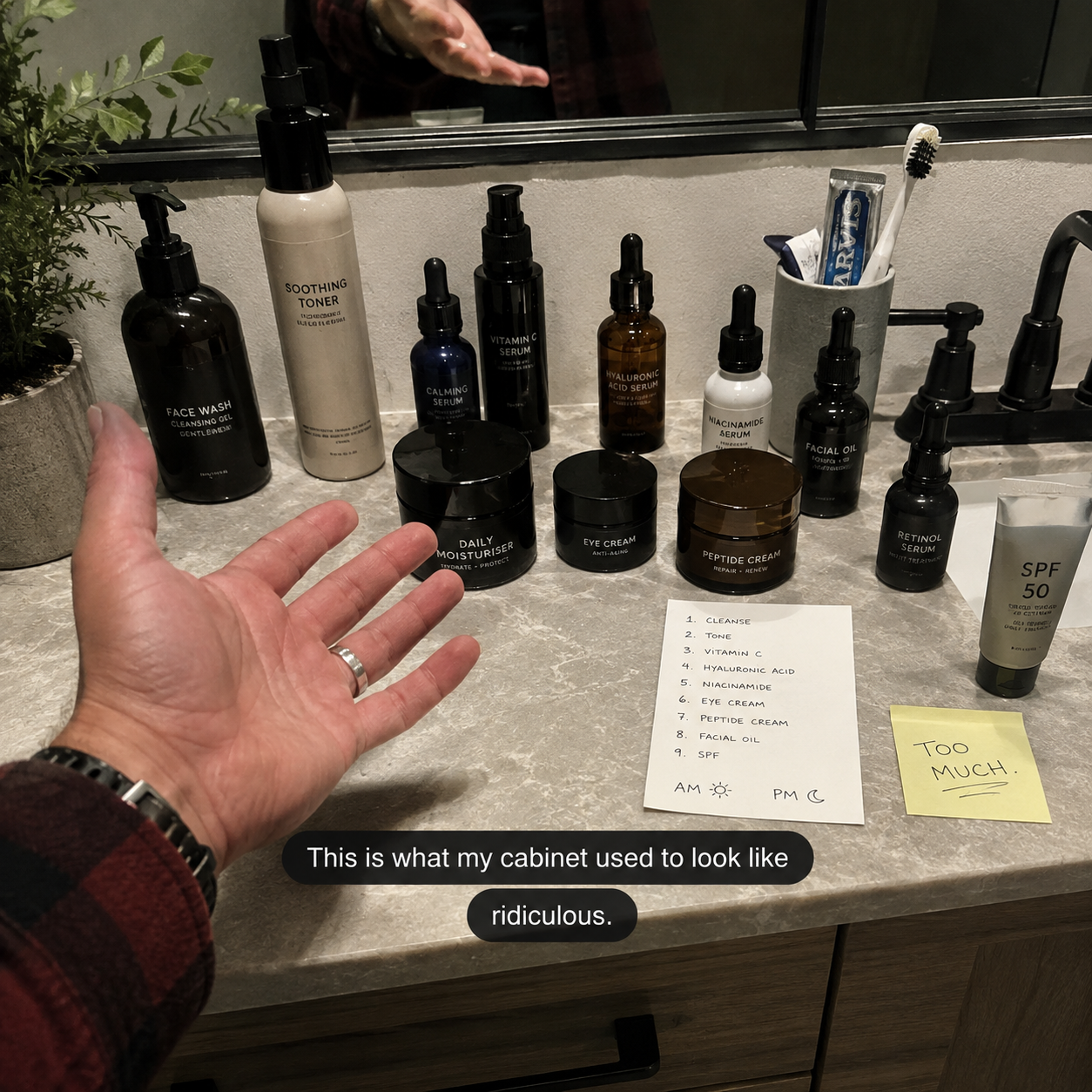 A person gesturing at a bathroom counter crowded with numerous skincare products and handwritten notes.