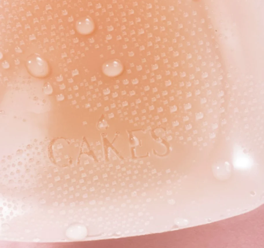 Close-up of a textured surface with water droplets and the word 'CAKES.'