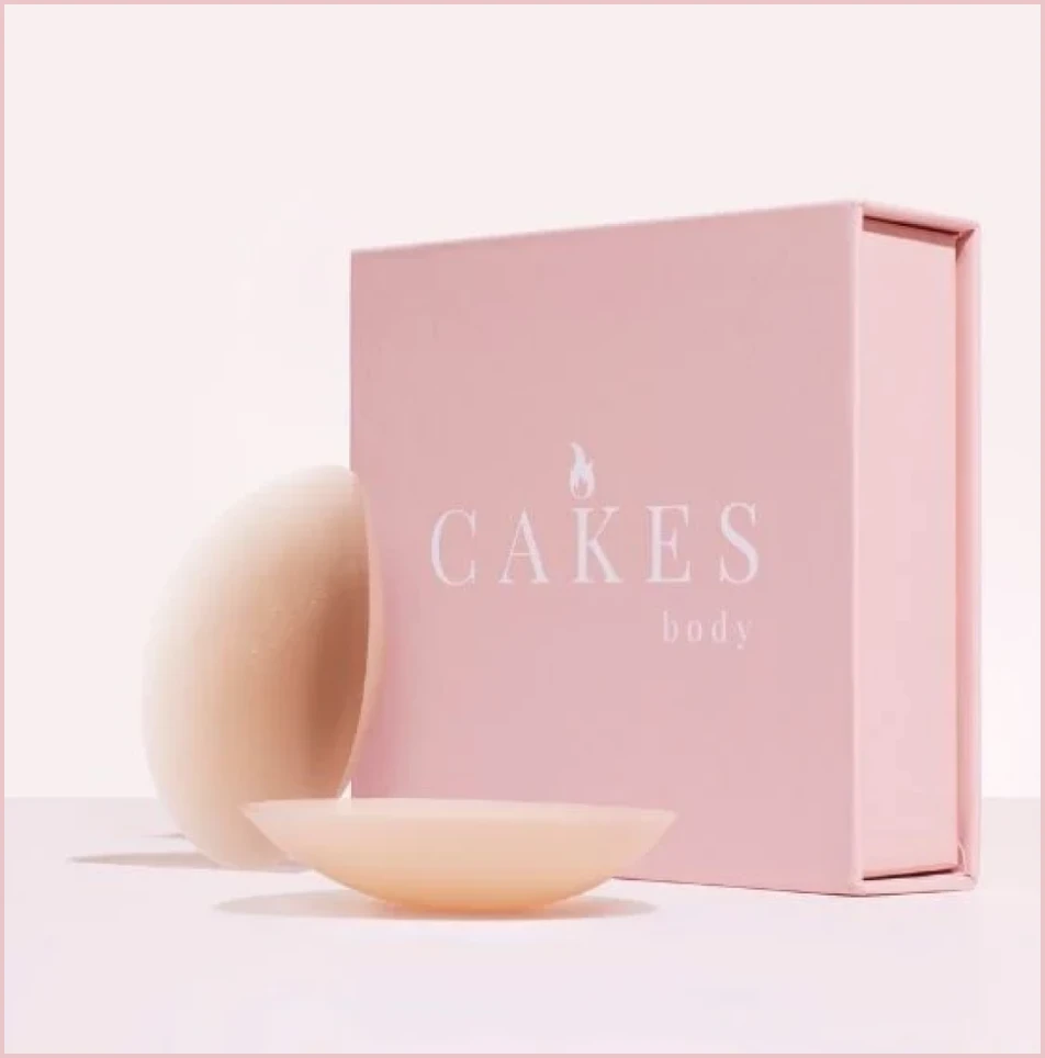 Pink box labeled 'CAKES body' with two beige pads in front.