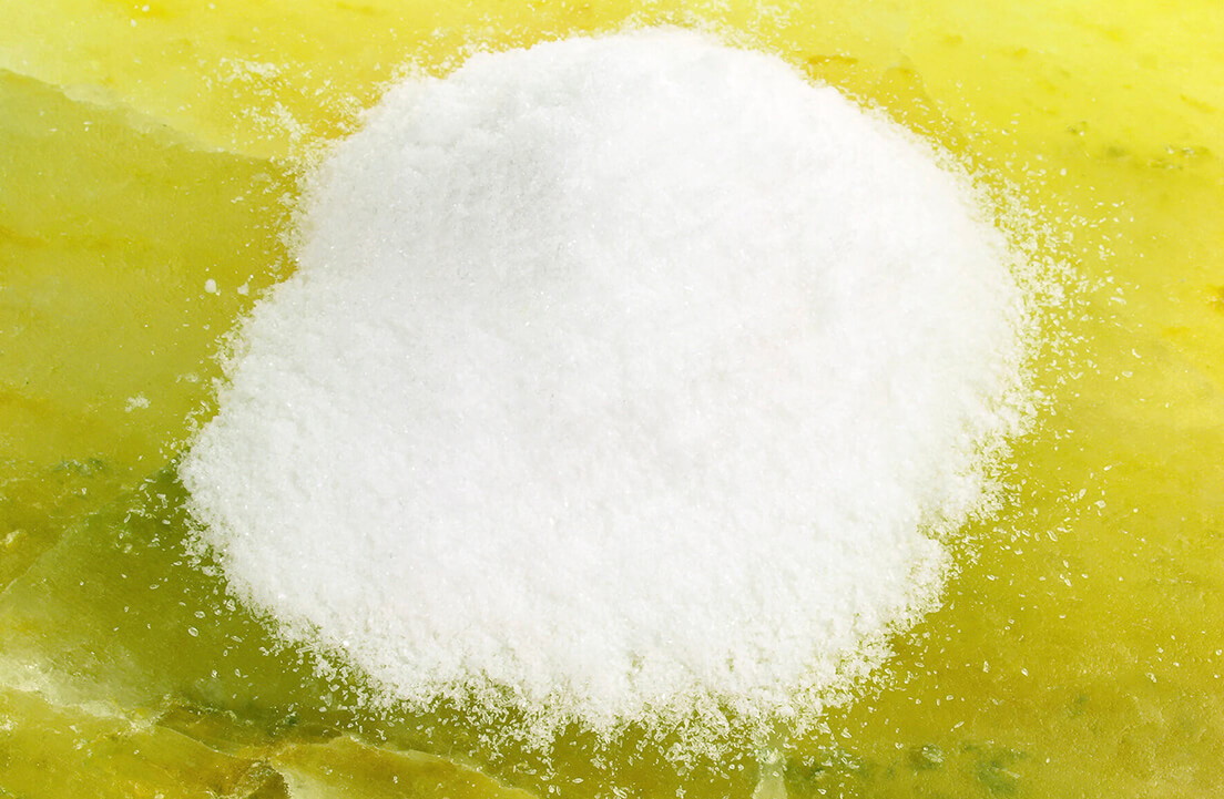 A pile of white powder on a yellow surface.