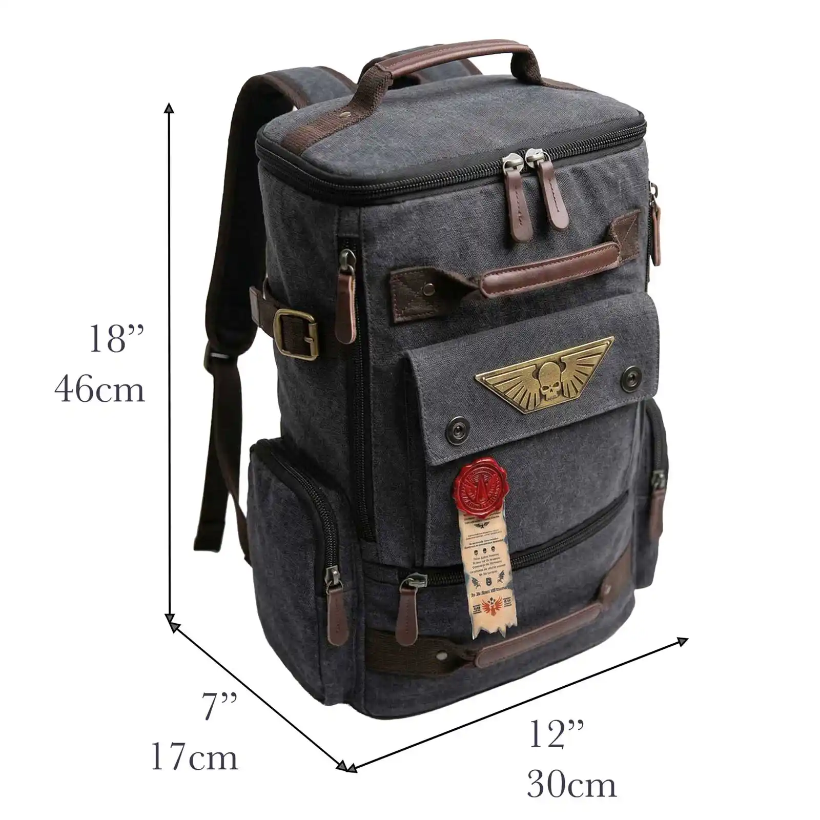 A dark grey canvas backpack with brown leather details, a winged skull emblem, and dimension labels.
