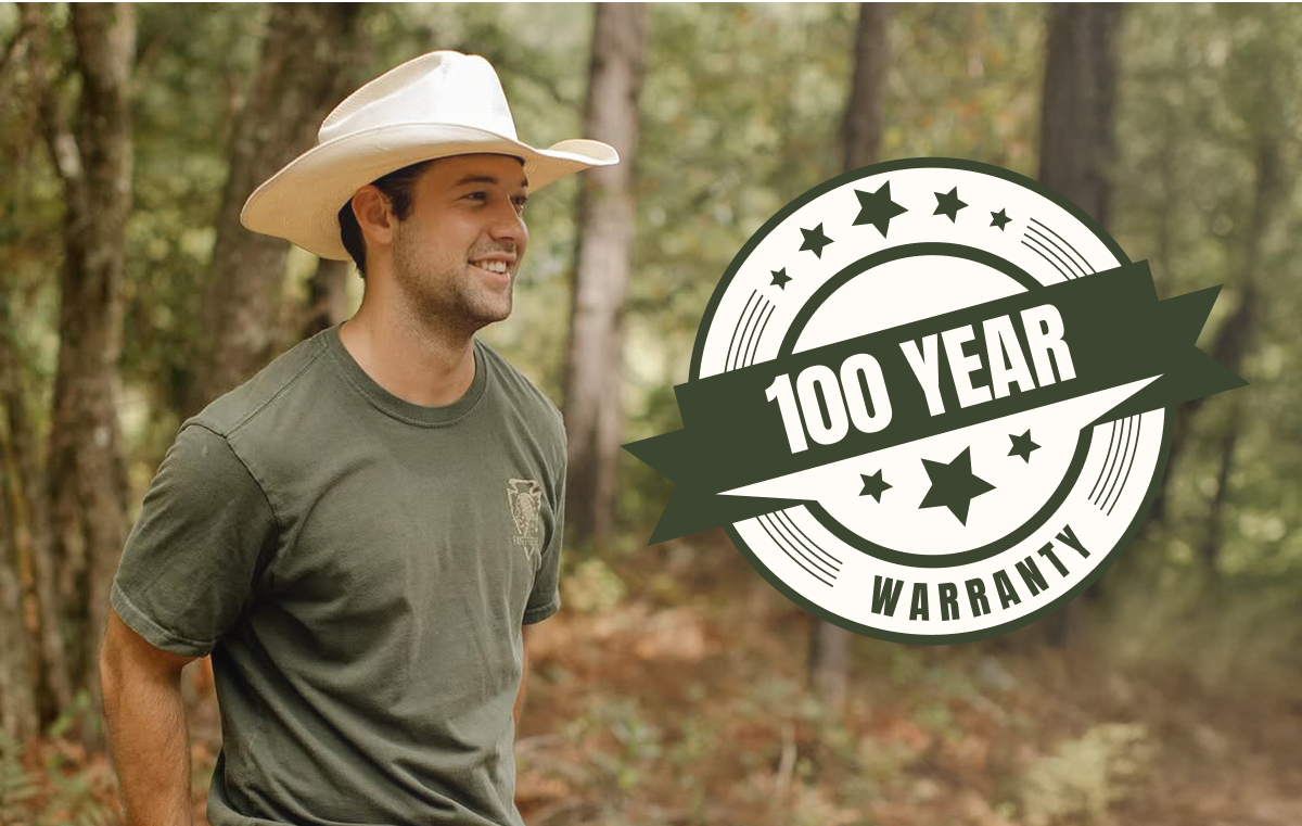 Man wearing cowboy hat in forest setting with '100 Year Warranty' badge.