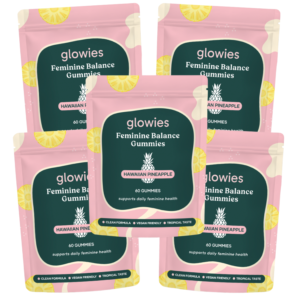 Five pink bags of Glowies Feminine Balance Gummies with Hawaiian Pineapple flavor.