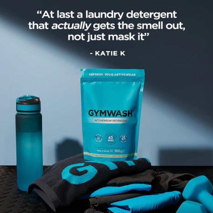 Blue Gymwash detergent package with a water bottle and gym towels.