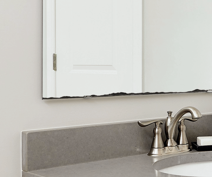 Bathroom sink with a mirror and silver faucet.