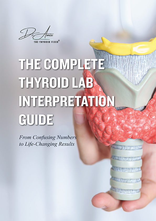 Hand holding a thyroid model with guide text beside it.