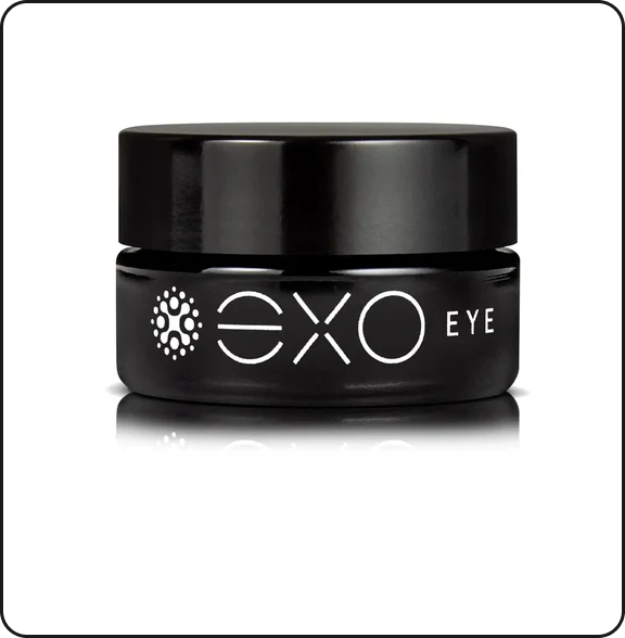 A small, round black jar labeled 'EXO EYE' in white text on a reflective white surface.