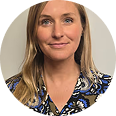 A circular headshot of a woman with blonde hair and blue eyes smiling slightly.