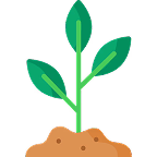A simple illustration of a green plant seedling with three leaves sprouting from a small pile of brown dirt.