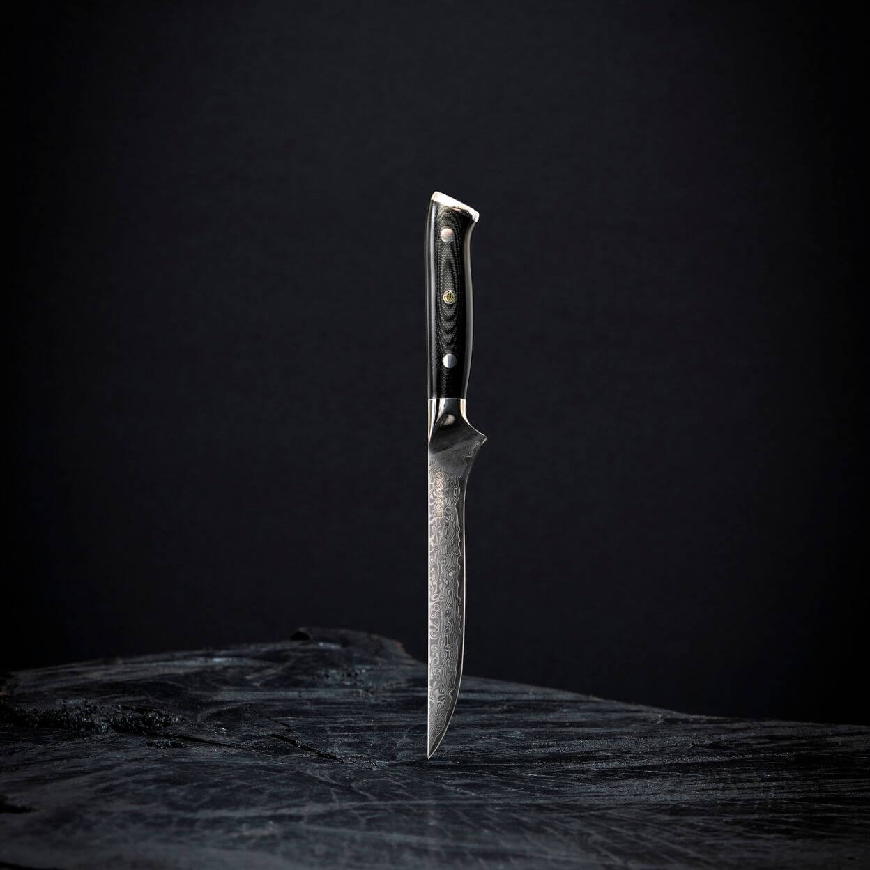 A single knife with a dark handle on a black background.